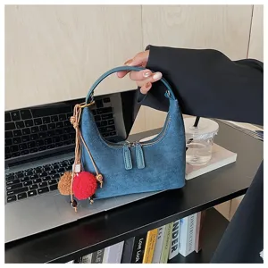 Blue suede hobo bag for women, retro dumpling shoulder bag with cute plush ball charms.