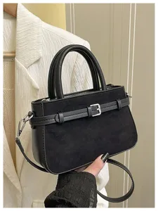 Black suede handbag with top handle and shoulder strap, perfect for daily commuting and office.