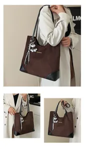 Detail view of large capacity suede tote bag, casual commuter shoulder bag daily use.