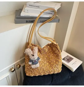 Detailed shot of the brown fuzzy shoulder bag featuring a cute bunny pendant and yellow straps.