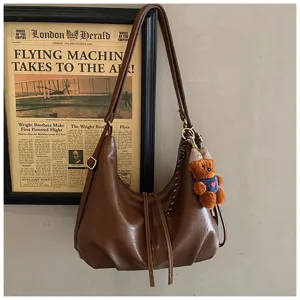 Vintage brown PU leather shoulder bag for women, large capacity daily commuting hobo bag.