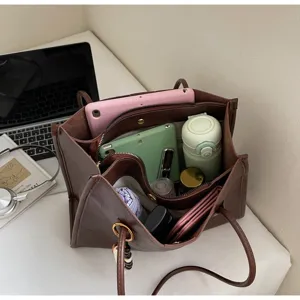 Brown PU leather tote bag with multi-compartments showing large capacity and daily essentials inside.