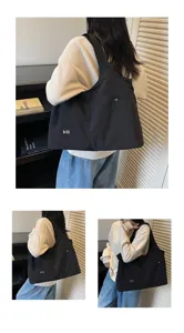 Detail view of casual black oxford cloth shoulder bag, large capacity daily underarm tote bag.