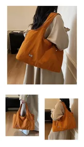 Detail view of the orange oxford cloth tote shoulder bag, showcasing large capacity design.