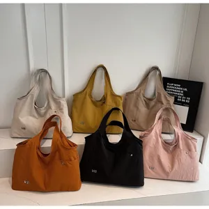 Oxford cloth tote bag detail showing multiple colors and large capacity for casual daily use.