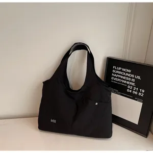 Casual black oxford cloth shoulder bag, large capacity tote for daily commuting and travel.