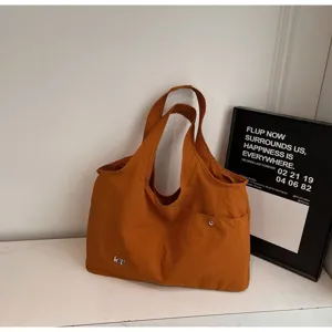 Orange oxford cloth tote bag detail, casual large capacity shoulder bag for daily use.