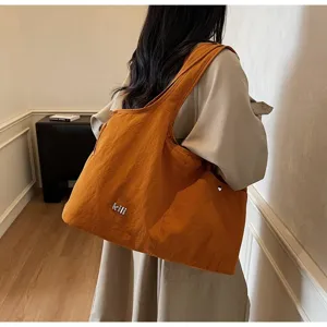 Detailed view of casual orange oxford cloth shoulder bag, large capacity daily tote purse.