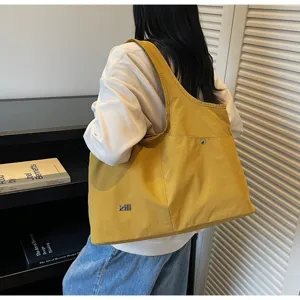 Detailed view of the casual yellow oxford cloth shoulder bag showcasing large capacity.