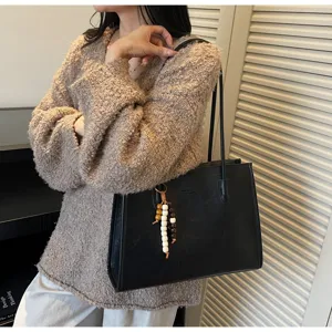 Large capacity black leather shoulder bag with chic wooden bead charm for daily commuting retro tote.