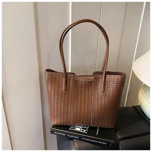 Detail shot of brown woven leather tote bag showcasing premium texture and large capacity design.