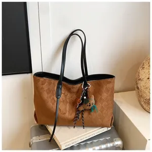 Brown suede quilted tote bag detail, retro commuting shoulder bag with cute pendants.