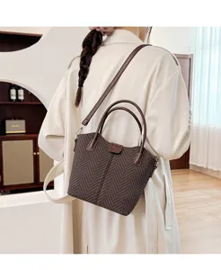 Autumn winter casual herringbone tote and shoulder crossbody bag worn by model detail view.