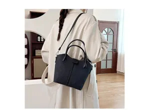 Detail view of the women's casual black tote shoulder and crossbody bag showcasing its texture.