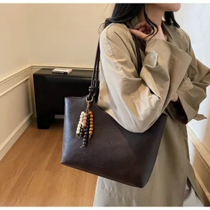 Retro brown PU leather tote bag with bead pendant, large shoulder bag for commuting.