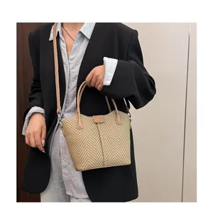 Woven straw handbag for women, casual crossbody shoulder bag with chic leather trim.