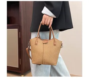 Close-up detail of the brown herringbone woven tote and shoulder bag showing textured fabric.