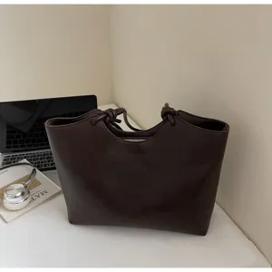 Dark brown minimalist leather tote bag for women, stylish commute shoulder bag with knot handles.