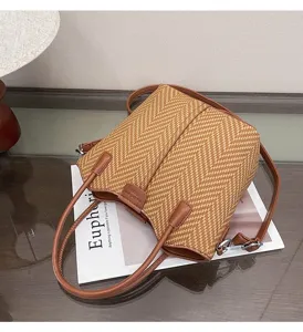Detailed view of the stylish brown woven shoulder bag with PU leather handles, casual design.