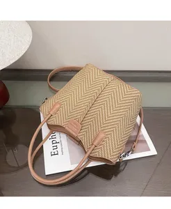 Detailed shot of woven straw handbag texture, featuring PU leather trim and chic design.