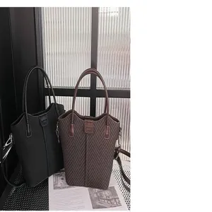 Close-up of stylish chevron pattern women handbag with dual handles in casual style
