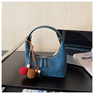 Stylish dark blue suede dumpling shoulder bag for women, trendy autumn winter handbag.