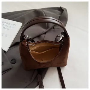 Brown suede dumpling bag detail, retro hobo shoulder handbag with zipper and inner pocket.