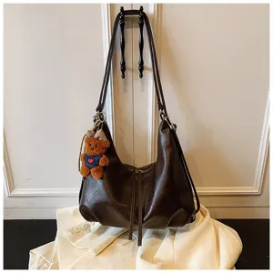 Stylish dark brown PU leather shoulder bag, large capacity commuter backpack with bear pendant.