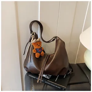 Brown PU leather shoulder underarm bag with cute plush bear pendant for autumn winter.
