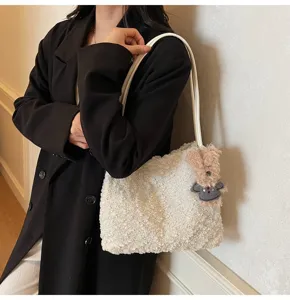 Detail view of a fashionable white plush shoulder bag for women, cute fluffy handbag style.