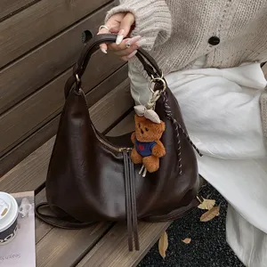 Stylish brown PU leather hobo shoulder bag for women, large capacity minimalist commuting backpack.