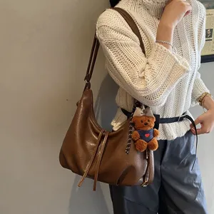 Stylish autumn winter PU leather shoulder backpack, large capacity commuter bag with bear pendant.