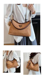 Detailed view of the brown suede shoulder bag, featuring contrast trim and cute bear charm.