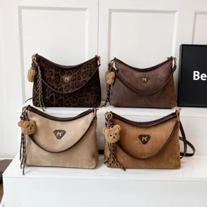 Chic suede shoulder bag with cute bear pendant, large capacity casual crossbody tote for women.