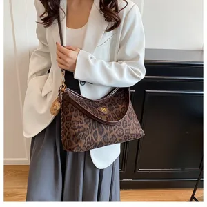 Leopard print shoulder bag for women, stylish underarm tote bag with soft velour fabric.