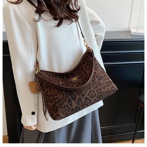 Closeup detail of the stylish leopard print velvet underarm shoulder bag for women.