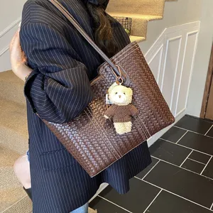 Retro woven leather tote bag for women, large capacity shoulder bag with cute bear keychain.