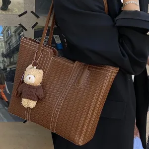 Vintage woven tote bag for women, large capacity stylish shoulder handbag with cute bear pendant.