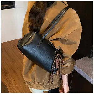 Classic black PU leather bowling shoulder bag, stylish retro underarm pillow bag detail.