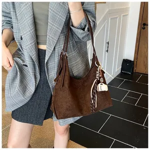 Detailed view of the brown vintage suede shoulder bag showcasing its large capacity and charm.