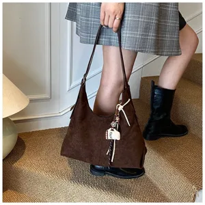 Detail view of the autumn winter vintage brown suede shoulder bag for women commuting.