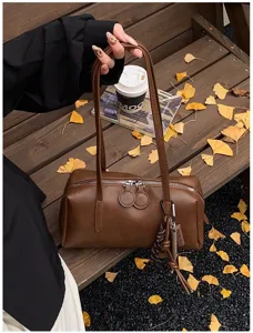 Retro brown PU leather bowling shoulder bag, chic underarm pillow handbag for women, daily commute.