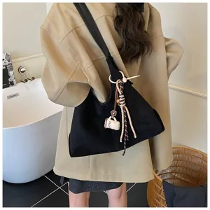 Detail view of a vintage black suede shoulder bag, large capacity slouchy hobo bag for women.