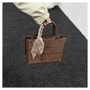 Brown suede tote bag with stylish patterned scarf and letter embroidery for women chic daily use.