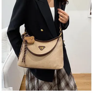 Suede shoulder crossbody bag for women, trendy large capacity underarm bag with bear pendant.