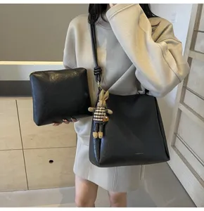 Black PU leather shoulder bucket bag set with matching clutch and cute bunny pendant for women.