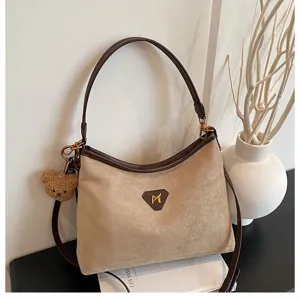 Brown suede shoulder bag hobo handbag with cute bear pendant for women daily use.