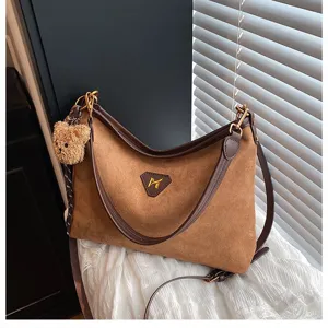 Brown suede shoulder bag with bear pendant stylish underarm handbag for daily wear