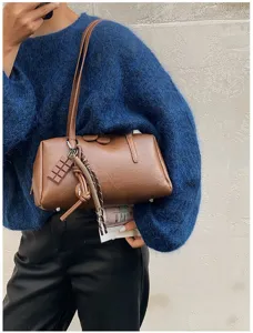 Detailed view of a brown PU leather retro bowling shoulder bag with cute chocolate charm.