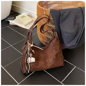 Vintage brown suede shoulder bag for women, large capacity hobo bucket bag with cute charm.